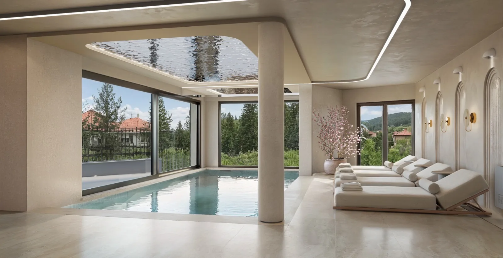 Indoor pool spa with lounge chairs, skylights, and framed mountain views.