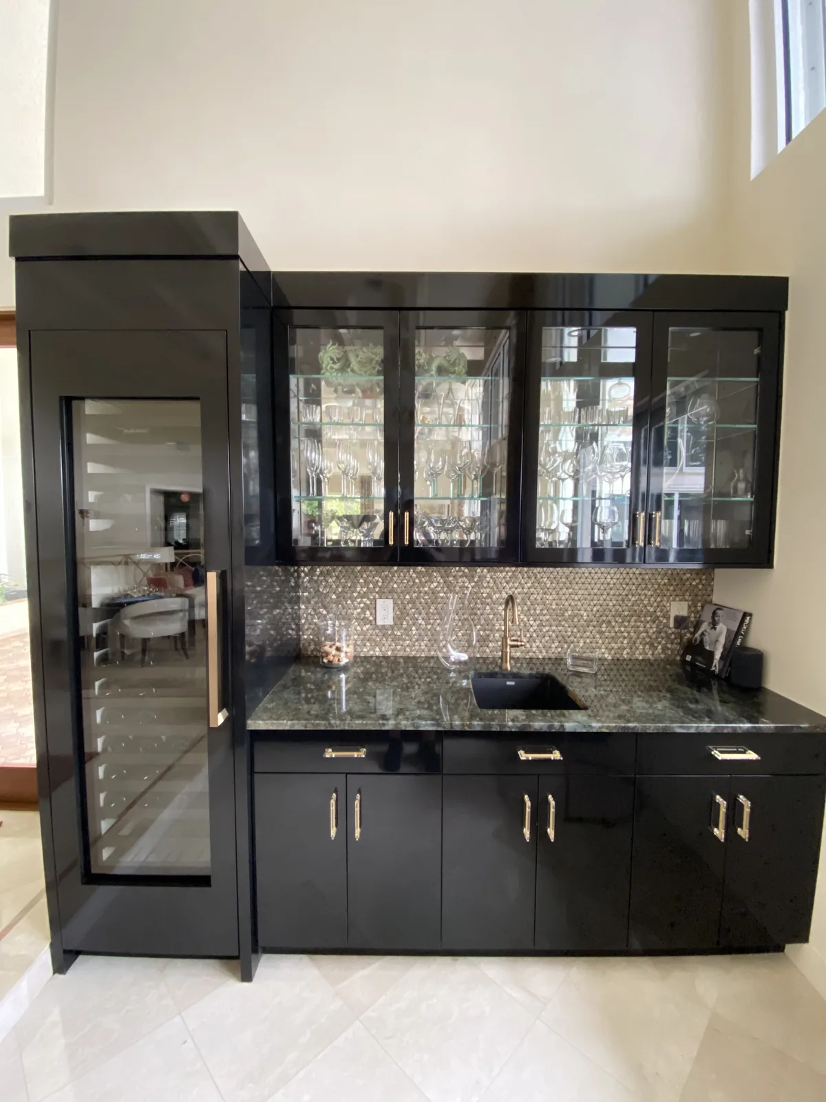Black kitchen cabinetry with glass-front uppers and integrated wine cooler.