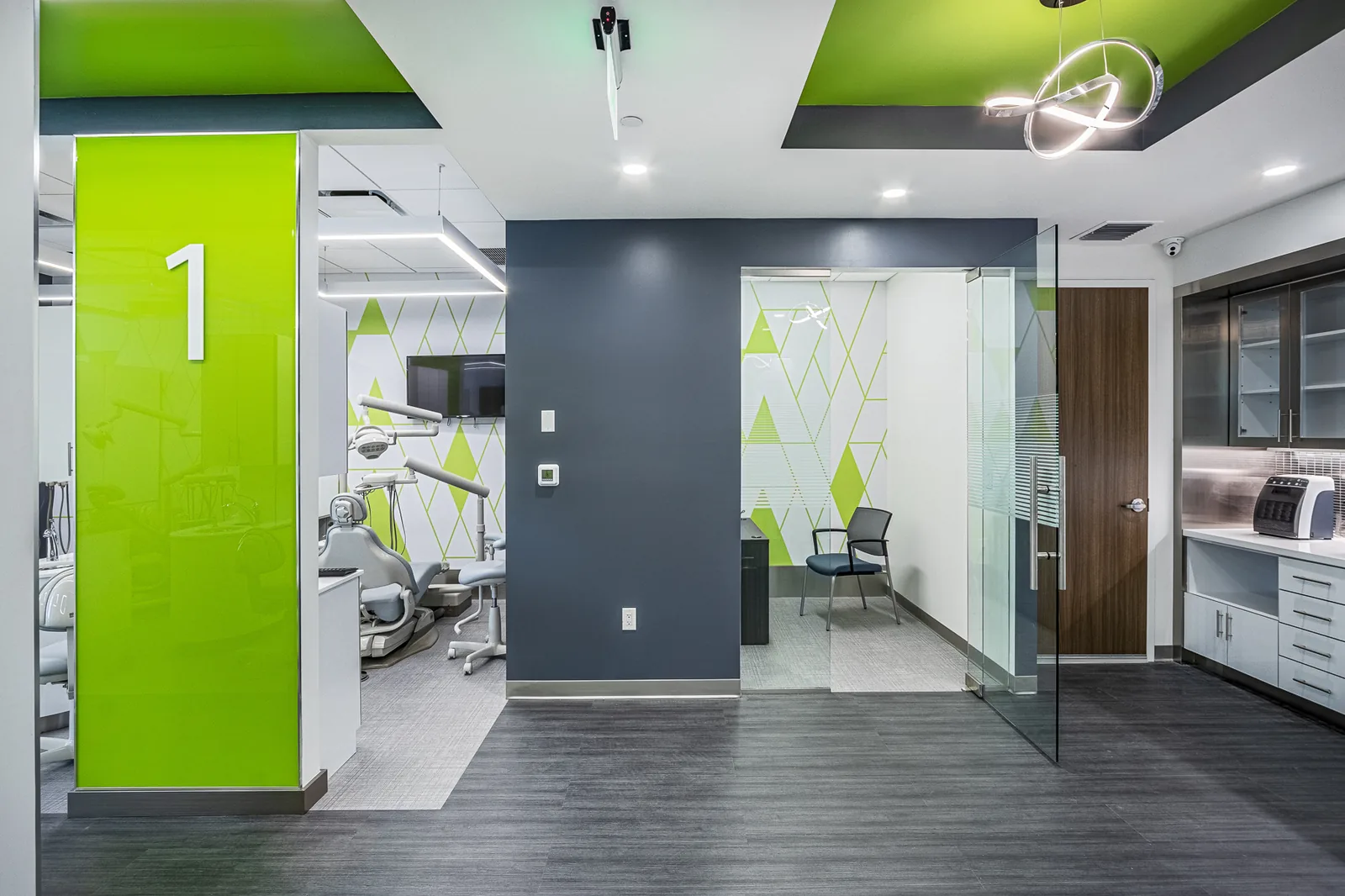 Dental office reception with bright lime green accent wall and dark blue feature wall.