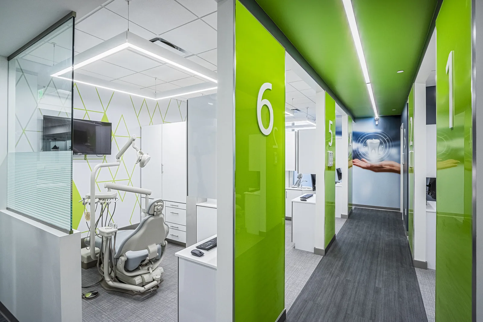 Dental clinic corridor with numbered treatment rooms and lime green accents.