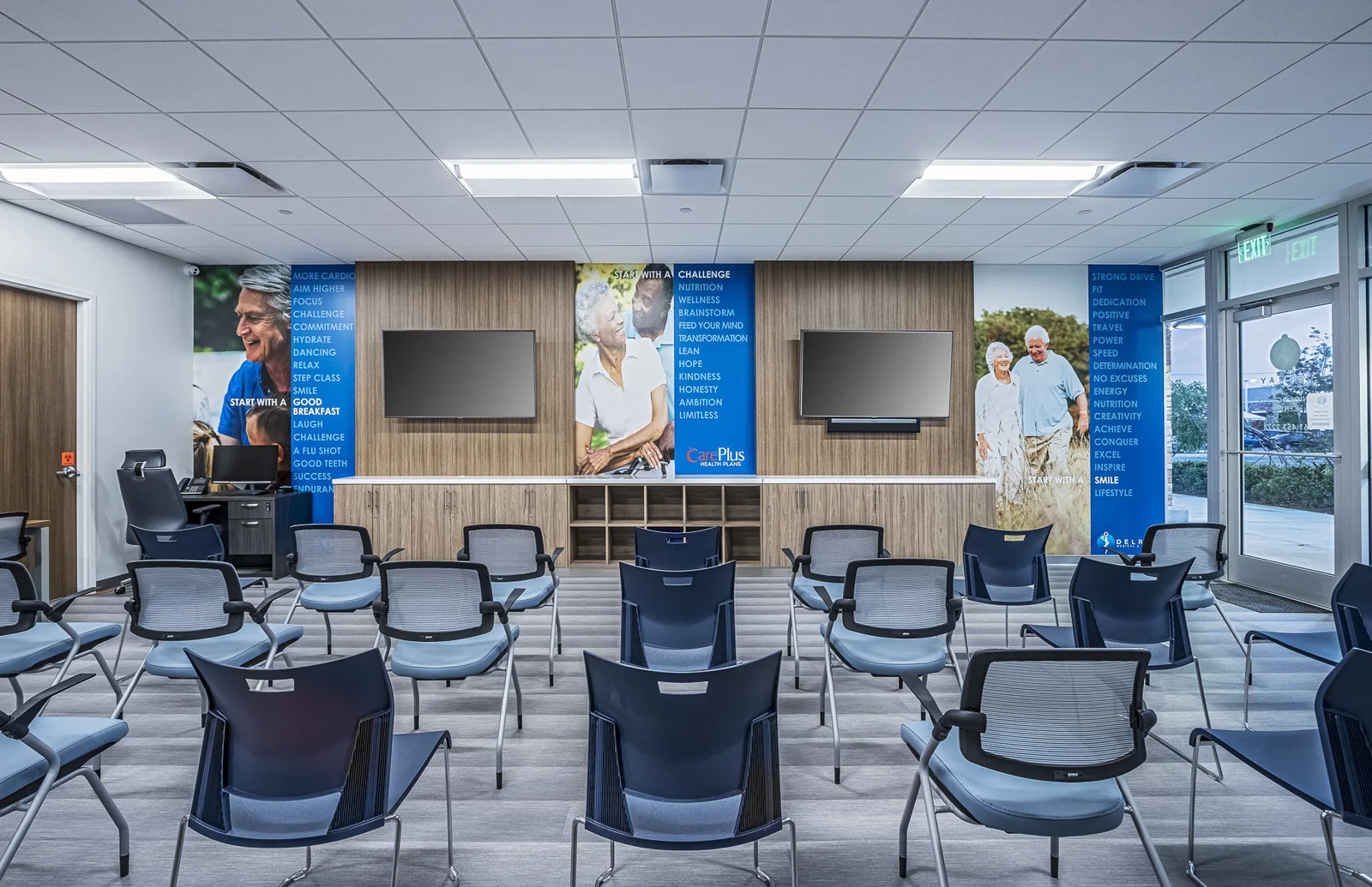 Fitness facility with motivational wall graphics and theater-style seating.