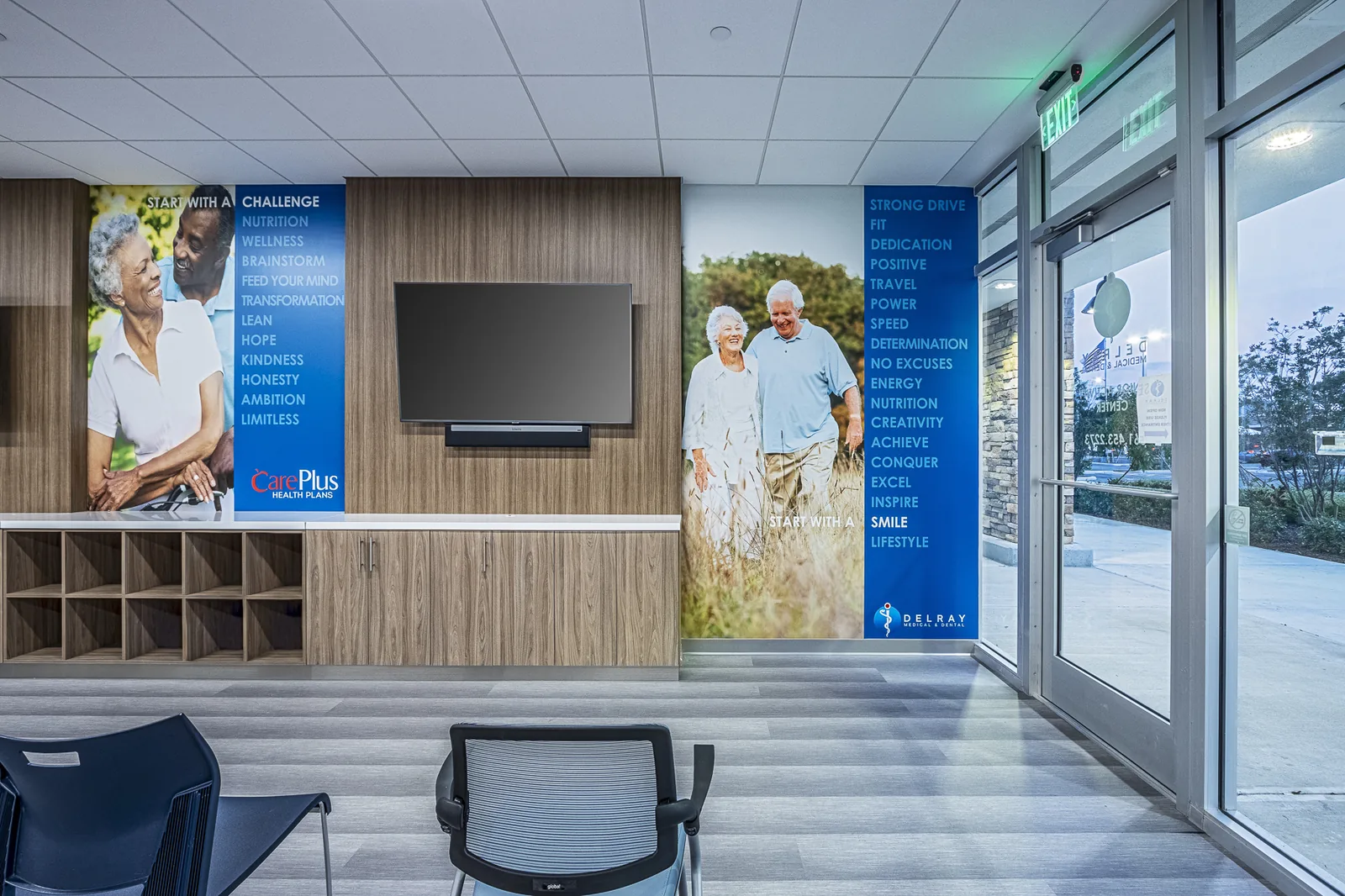 Medical clinic waiting room with wood cabinetry and motivational signage.